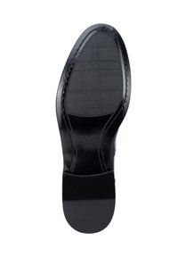 Black leather shoe sole with textured pattern and smooth edges. Features a raised heel and branding embossed on the side.