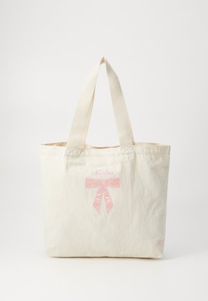 Canvas tote bag in cream, featuring pink embroidered bow detail and "New Era" text. Solid handles, rectangular shape, soft texture.