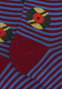 Multicolored socks featuring red and blue stripes, adorned with a pattern of vinyl records in yellow, green, and red.