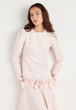 Light pink long-sleeve dress featuring floral patterns, puffed sleeves, and a gathered waist with bow accents. Smooth satin texture.