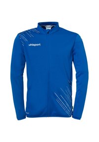 Blå sportsjakke lavet af glat stof, med høj krave, fuld lynlås og hvide diagonale linjer på venstre side.