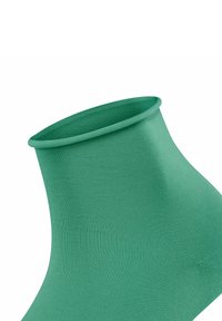 Grüne Knöchelsocke aus geripptem Material, mit einer glatten Textur und einem abgerundeten oberen Rand. Keine Muster oder sichtbaren Beschläge.