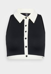 Black crop top with a textured finish, featuring a white collar, button front, and white hem accent. No sleeves, modern design.