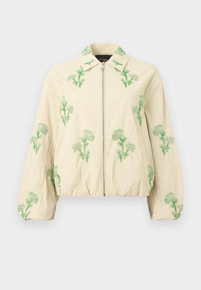 Μπεζ ζακέτα με φερμουάρ, ελαστική λωρίδα κάτω και στα μανίκια, με πράσινα κεντημένα λουλουδάτα σχέδια στα μανίκια, το γιακά και το μπροστινό μέρος.