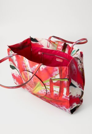 Large tote bag with vibrant floral print in shades of red and pink. Made of durable fabric, features leather handles and a pink interior pocket.