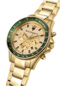 Guldtonet Maserati ur med en grøn bezel, en champagne urskive, tre sub-dials, sorte timemarkører og et metal link armbånd. Vandtæt ned til 100 meter.