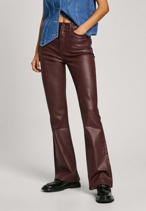 Burgundy leather flared pants with a smooth texture and high waist, paired with a denim vest. Black shoes complete the outfit.