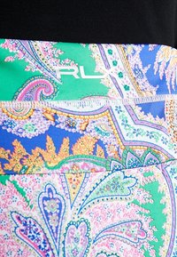 Leggings featuring a vibrant paisley pattern in blue, green, pink, and orange. Smooth, stretchy fabric with an "RLX" logo detail.