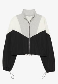 Afgeknipte jas met ritssluiting en hoge kraag. Kleurvlakken in grijs, wit en zwart. Gemaakt van gladde stof, voorzien van elastische manchetten en trekkoorden.