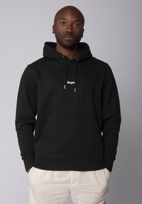 Zwarte hoodie van katoenblend met een voorzak. Bevat een witte print met de tekst "Nope." op de borst en heeft trekkoorden voor aanpassing.