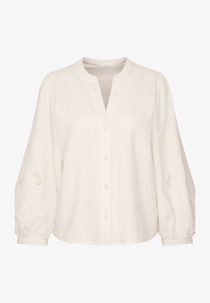 Blusa bianca in lino con colletto a bande, chiusura a bottoni sul davanti e maniche voluminose con motivi floreali ricamati lungo i polsini.