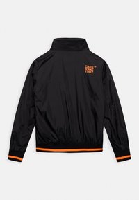 Black, lightweight jacket with a stand collar. Features orange logo text and accents on cuffs and hem. Smooth texture and elastic waistband.