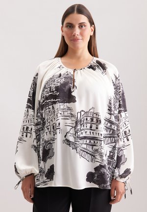 Blusa a maniche lunghe in tessuto bianco con stampa architettonica nera, scollatura tonda con dettaglio a occhiello, spalle arricciate e legature ai polsini.