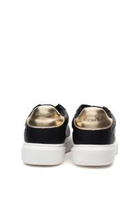 Black leather sneakers with gold accents at the heel, white rubber sole, and patterned detailing on the back. Designed for casual wear.
