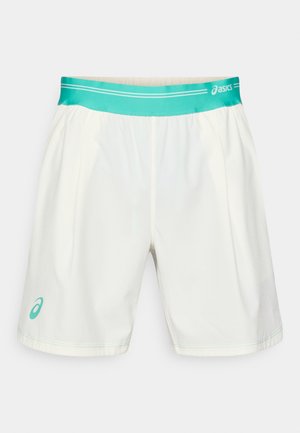 Shorts de sport blancs en tissu léger, avec une taille turquoise et un petit logo de la même couleur sur la jambe gauche.