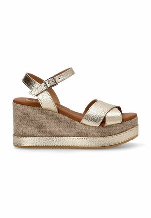 Sandalias de cuña con parte superior sintética dorada metálica, correa ajustable en el tobillo y suela de plataforma texturizada de yute. Suela de goma plana.