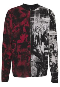 Graphic sweatshirt featuring a split design: red side with skull patterns, black side with monochromatic figures. Zipper closure, long sleeves.
