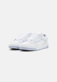 White athletic sneakers with a smooth leather upper, textured toe cap, and light blue accents. Lace-up design with a sturdy rubber sole.