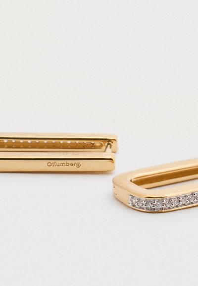 Δύο χρυσά κλιπ για τα μαλλιά με ορθογώνια σχήματα. Το ένα έχει λεία επιφάνεια· το άλλο διαθέτει μια σειρά από ενσωματωμένους διαυγείς λίθους κατά μήκος μιας άκρης.