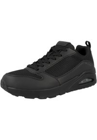 Scarpa sportiva nera con sovrapposizione in rete e sintetico, dotata di lacci, colletto imbottito e un'unità di ammortizzazione ad aria visibile nella suola.