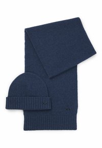 Navy blue knitted scarf and beanie set, featuring a ribbed hem on the beanie and subtle texture throughout. Both pieces have logo accents.