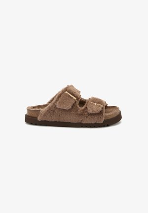 Faux fur slide sandal in brown, featuring two adjustable straps, textured surface, and a contrasting dark sole with a patterned footbed.