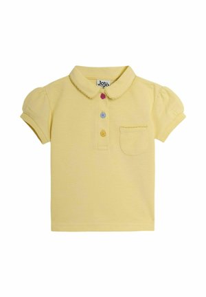 Polo shirt giallo con maniche corte a sbuffo, colletto, tre bottoni colorati e una piccola tasca frontale. Tessuto strutturato.