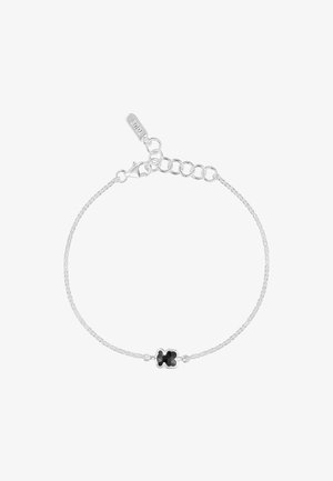 Srebrna bransoletka łańcuszkowa z centralnym czarnym kamieniem w kształcie kwiatu, z zapięciem na homara i regulowanym łańcuchem do dopasowania.