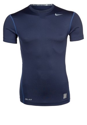 T-shirt de compression Nike Pro Combat Dri-FIT manches courtes bleu marine avec logo swoosh gris près de l'épaule et coutures bleues contrastées.