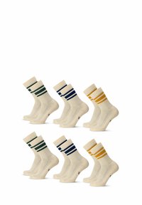 Frottésockar i krämfärg med kontrasterande mönstrade ränder. Tre par: mörkgrön, marinblå och senapsgul accent. Längd till mitten av vaden.