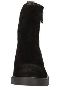 Black suede ankle boot with a rounded toe, side zipper, and a flat rubber sole. Features subtle stitching and a smooth texture.