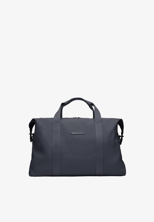 Sac de voyage gris foncé en matériau durable, équipé de deux poignées supérieures, d'une fermeture éclair et de forme rectangulaire. Design minimaliste.