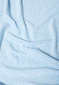 Tela azul claro con una textura suave, que presenta un patrón ligeramente jaspeado y una caída suave. Superficie lisa sin patrones ni acentos visibles.