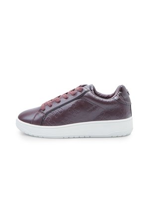 Purple leather sneaker with embossed logo pattern, round toe, padded collar, and white rubber sole. Features matching laces and textured finish.