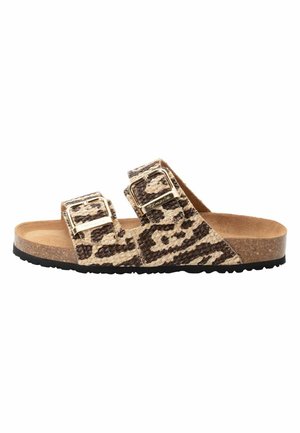 Leopard print slide sandals featuring two adjustable buckled straps, a cork footbed, and a textured black rubber sole.