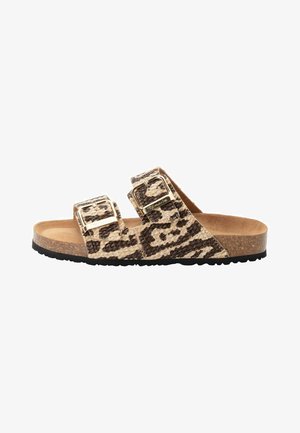 Leopard print slide sandals featuring two adjustable buckled straps, a cork footbed, and a textured black rubber sole.