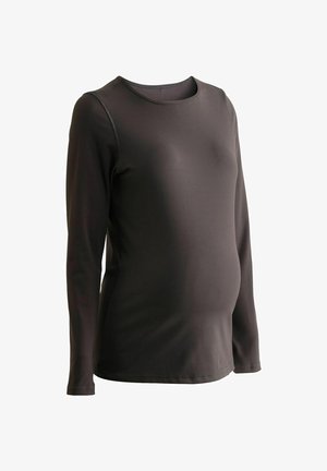 Juodas ilgomis rankovėmis nėštumo viršus, pagamintas iš lygaus elastingo audinio su apvaliu iškirpimu ir subtiliais siūlių akcentais. Tinkantis lieknas fasonas komfortui.