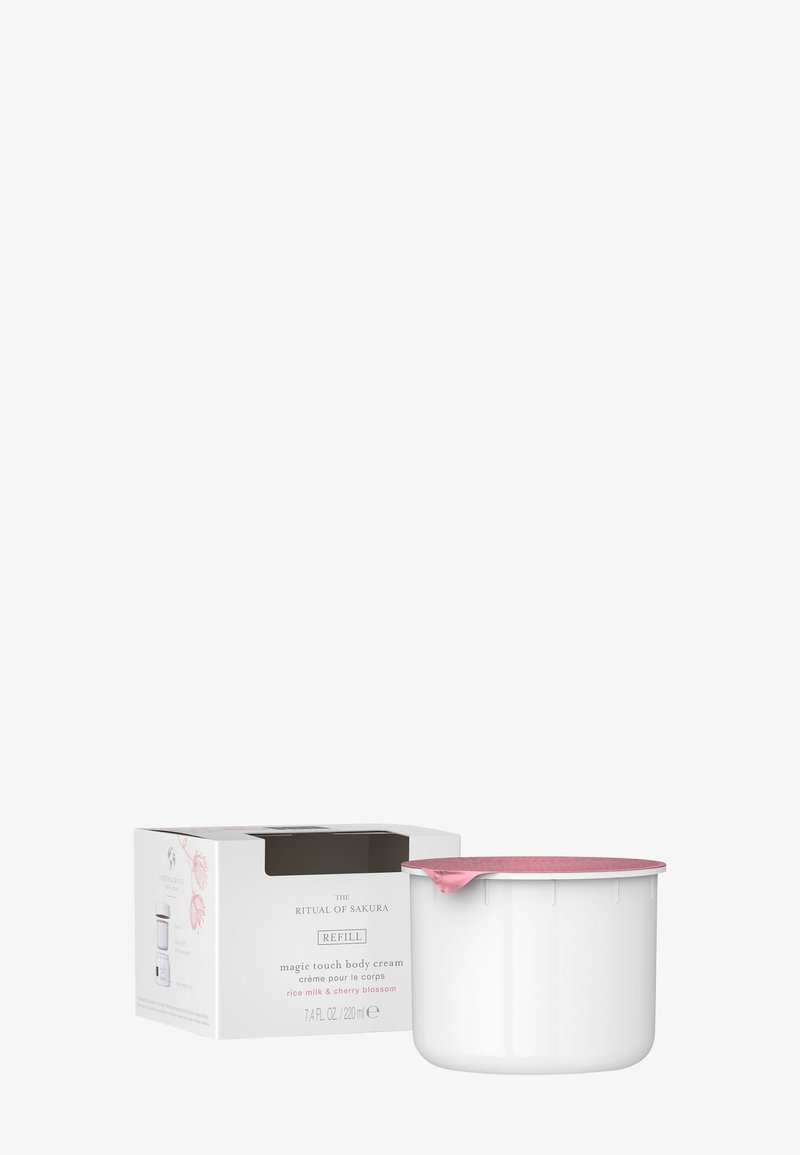 Recarga de crema corporal Ritual of Sakura Magic Touch con leche de arroz y flor de cerezo, 220 ml, envase blanco con tapa de papel de aluminio rosa.
