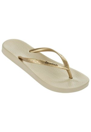 Infradito crema con una soletta testurizzata e cinturini dorati. Presenta un design minimalista con una suola in gomma resistente.