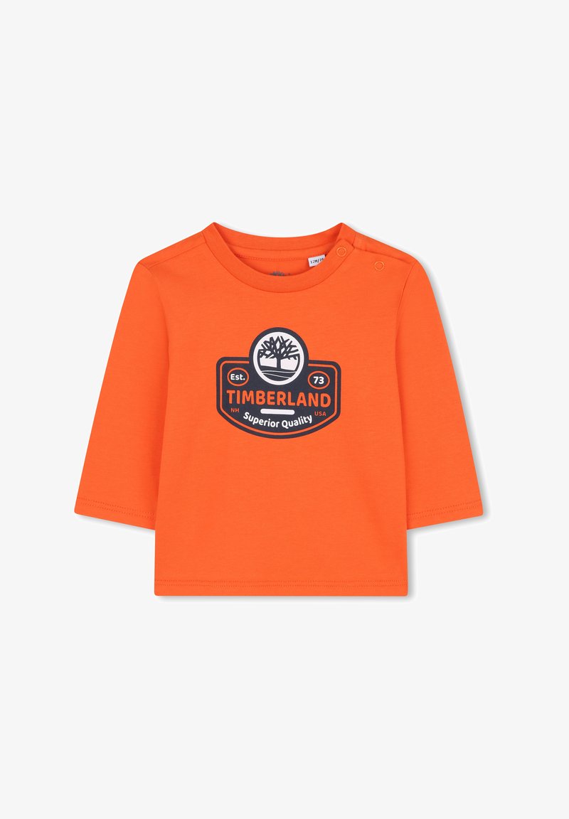 T-shirt arancione a maniche lunghe in cotone, con scollatura rotonda e bottoni a pressione sulla spalla. Dettaglio centrale del logo nero Timberland.
