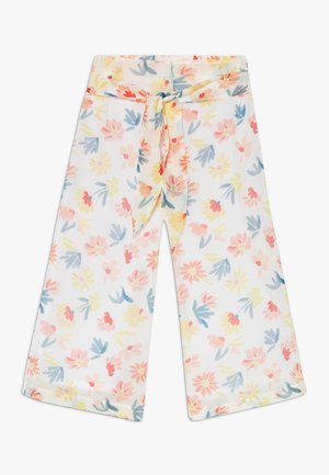 Pantalons larges à motifs floraux avec une base blanche, présentant des motifs floraux pastel en rose, jaune et bleu, et un détail de taille nouée.