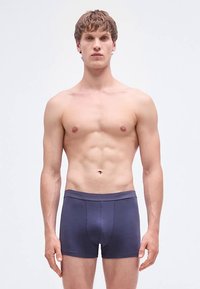 Herenboxershorts in donker marineblauw, gemaakt van zacht katoen. Voorzien van een flexibele tailleband en gestikte details, die strak om de dijen zitten.