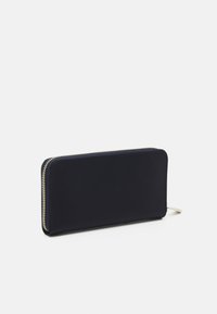 Navy zip-around wallet made of smooth material, featuring a minimalist rectangular design and gold-tone zipper accents.