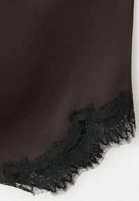 Black fabric with scalloped lace trim featuring floral patterns along the edge.