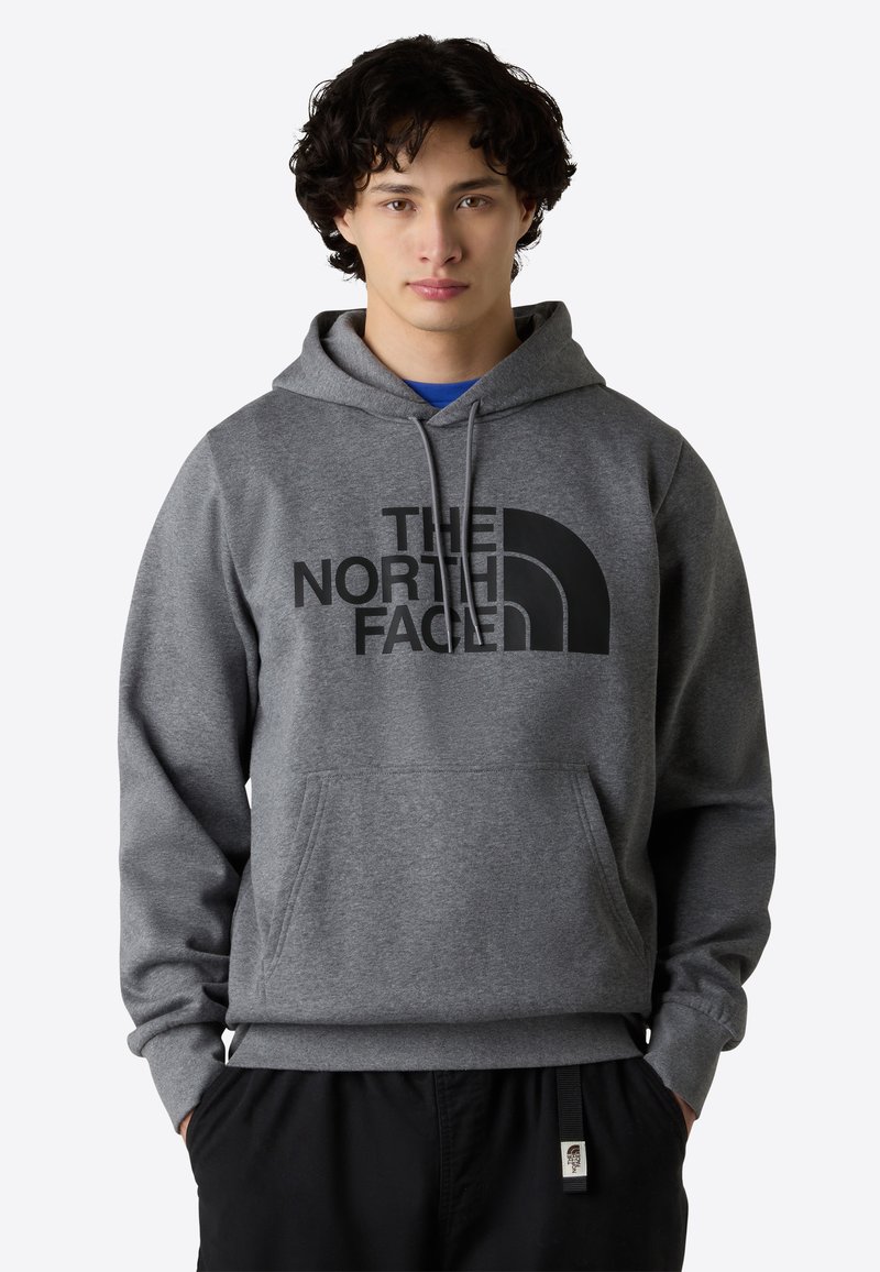 Grijze sweatshirt met capuchon, voorzien van een groot zwart logo op de voorkant. Zachte stof, kangoeroezak, geribbelde boorden en onderrand.