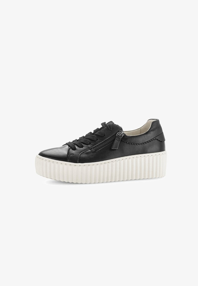Black leather sneaker with a round toe, flat white platform sole, textured sides, lace-up front, and a zip detail on the outer side.