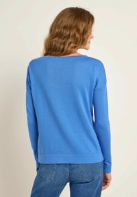 Blauer leichter Pullover mit langen Ärmeln und rundem Ausschnitt. Glatte Textur und entspannte Passform, gestaltet mit einfacher Nahtführung.
