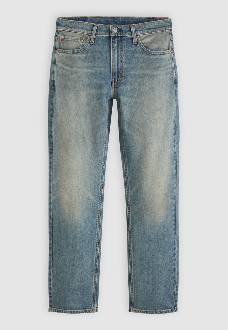 Blå falmede denimjeans med frontknap og lynlås, fem lommer og straight ben på en neutral baggrund.