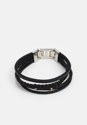 Bracelet noir à plusieurs rangs avec des bandes en cuir tressé et lisse, et une fermeture à clip en métal argenté sur fond blanc.