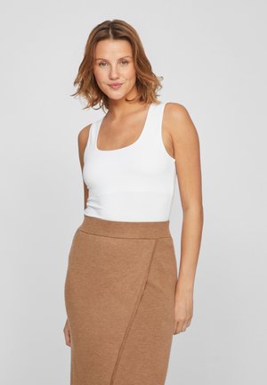 White sleeveless top with a square neckline paired with a tan pencil skirt featuring a diagonal seam detail. Smooth, fitted fabric.